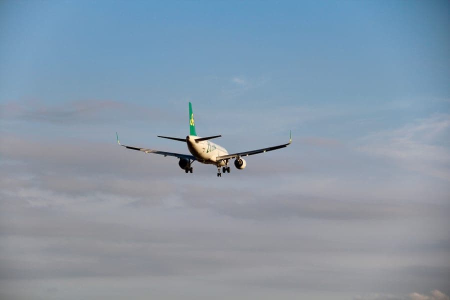 A commercial airplane descending against a clear sky