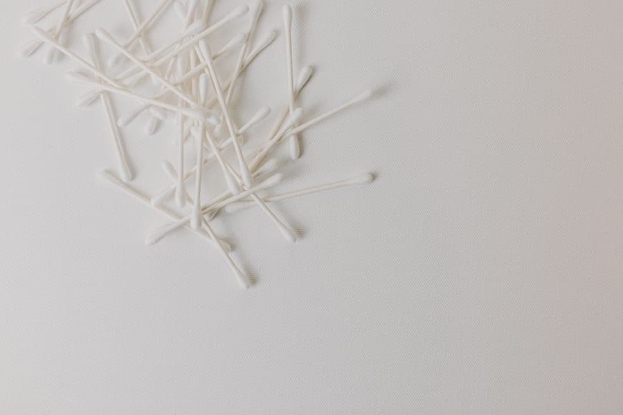 Cotton swabs arranged neatly on a white background