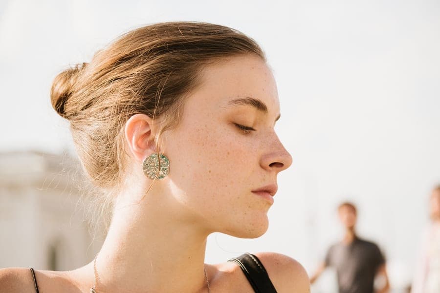 Profile of a person with their eyes closed in soft daylight