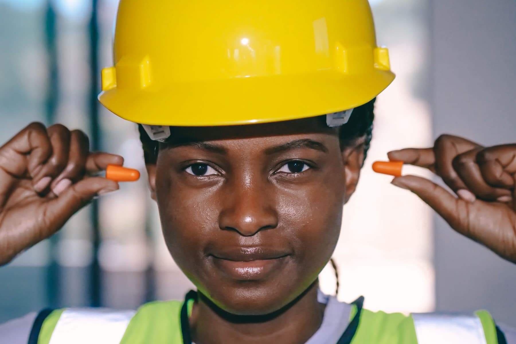 A worker in safety gear wearing over-ear hearing protection