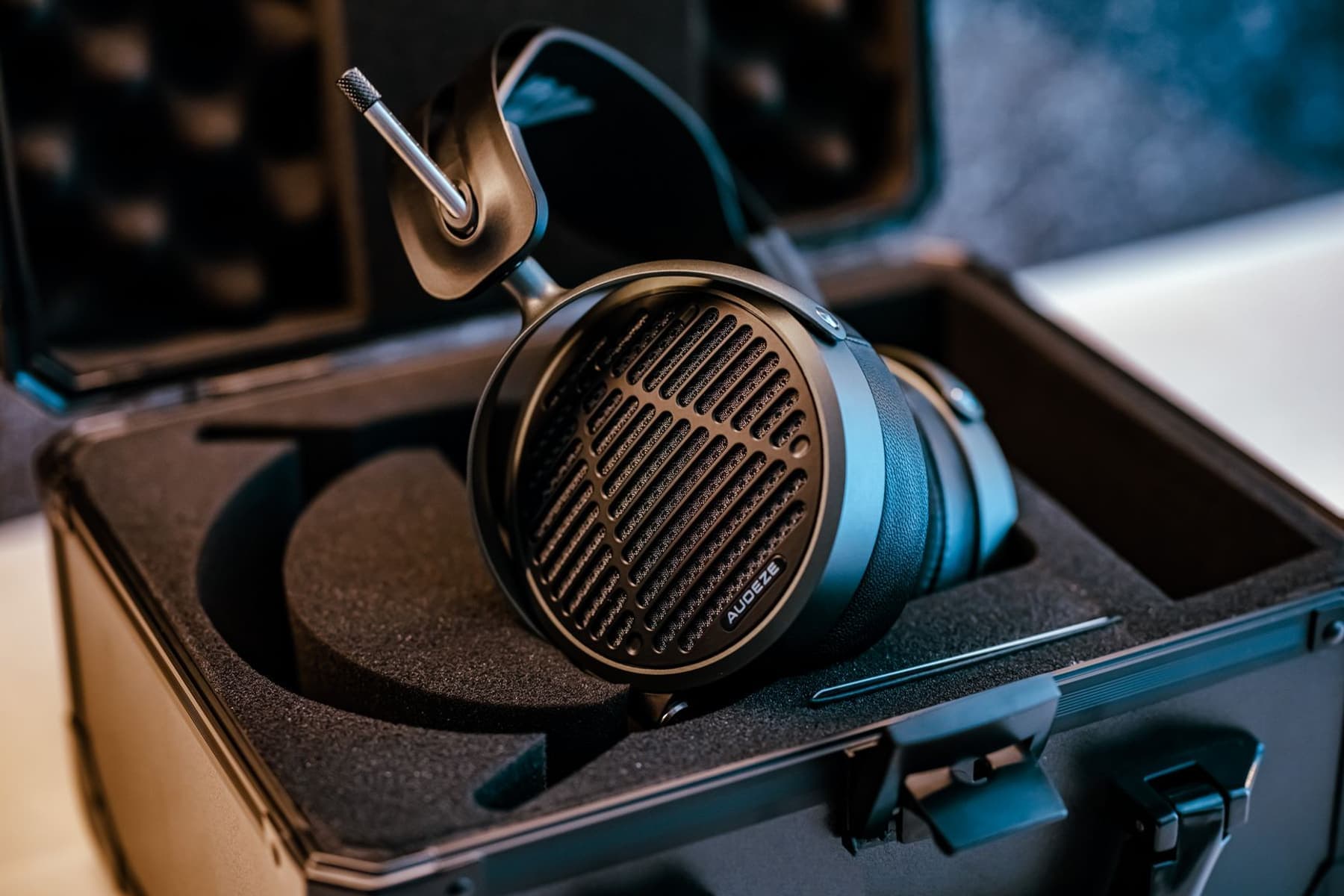 Over-ear headphones stored inside a protective carrying case