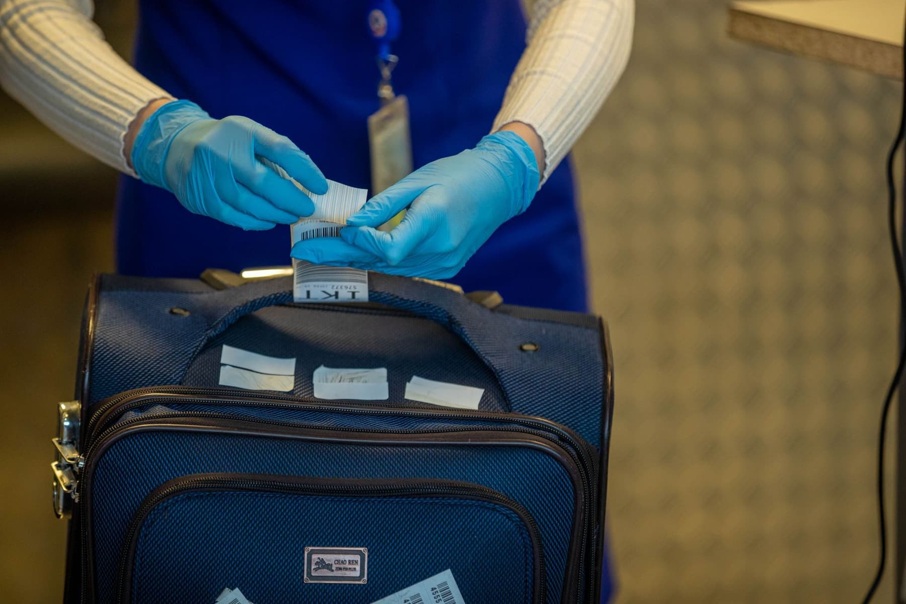 An airport security screening process with luggage being inspected