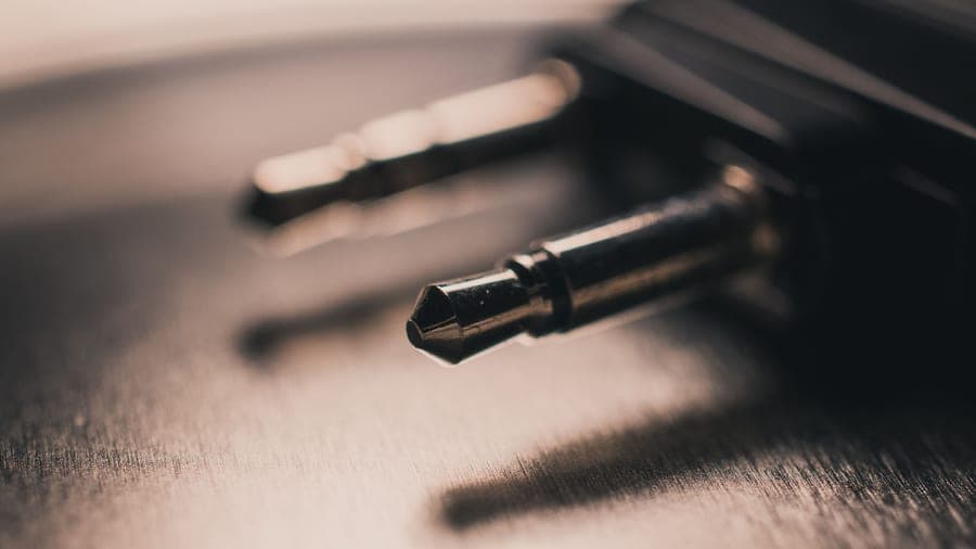 Close-up of a 3.5 mm audio connector on a brushed metal surface