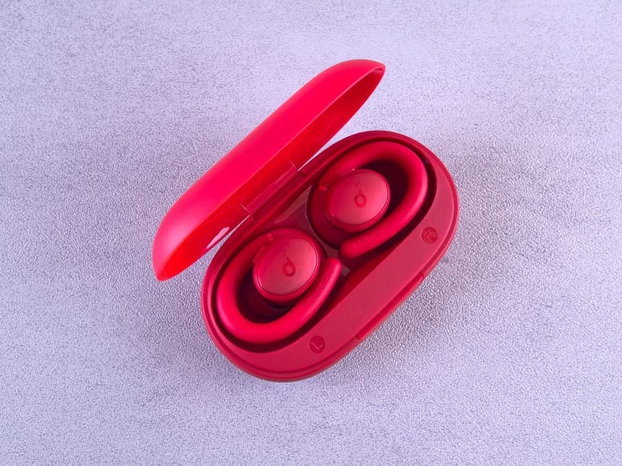 Wireless earbuds sitting in an open charging case, seen from above