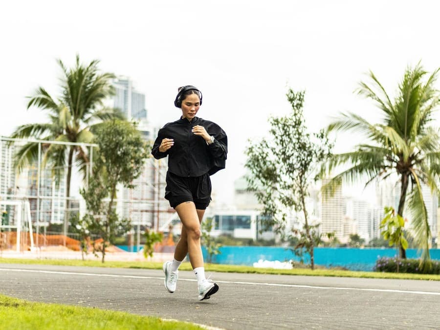 A runner on a park path during a morning run