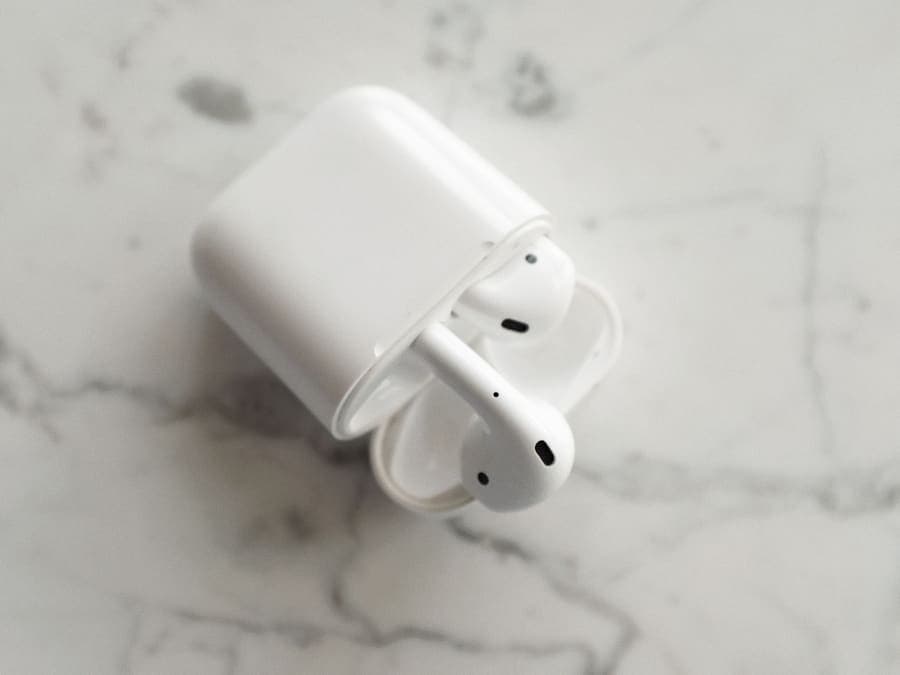 True wireless earbuds in an open charging case on a marble surface