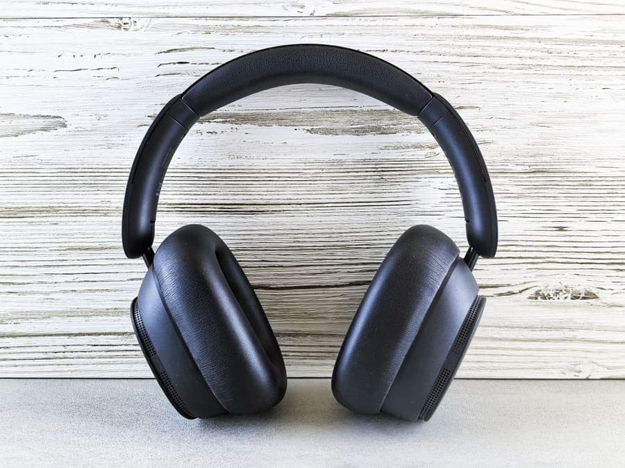 Black over-ear headphones against a wooden backdrop