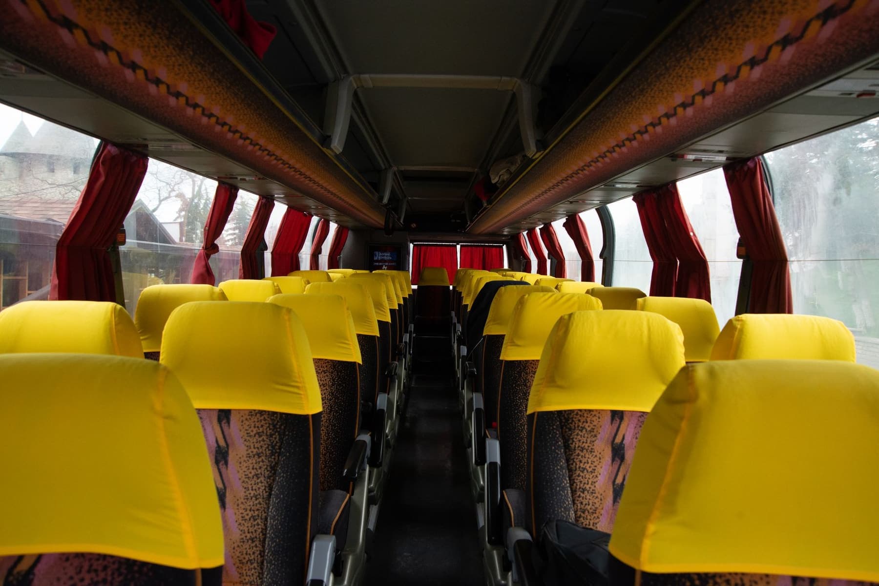 The interior of a long-distance coach with rows of empty seats
