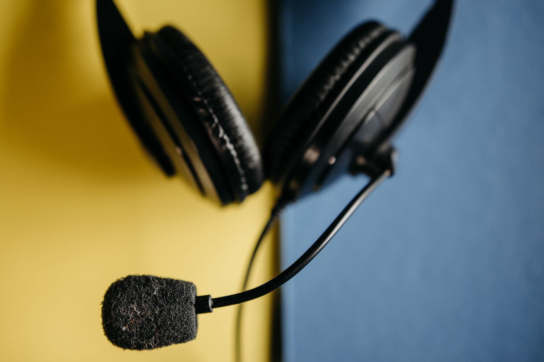 An office headset with a boom microphone on a desk