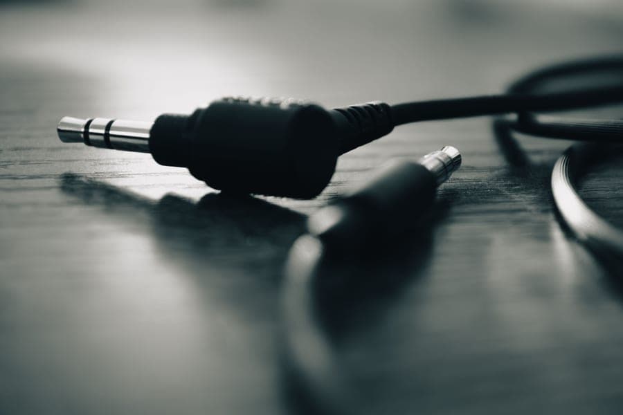 Close-up of an audio jack connector on a wooden surface