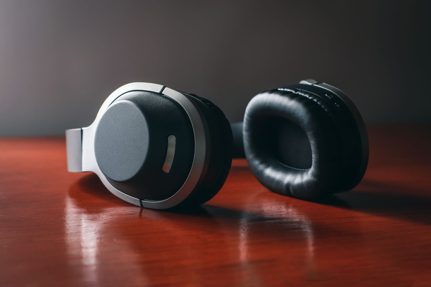 Wireless over-ear headphones resting on a plain table